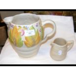 A Clarice Cliff jug with floral pattern, together