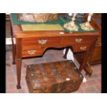 An Edwardian writing desk with green leather top