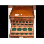 A mahogany twelve drawer coin collector's cabinet