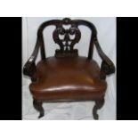 A scroll arm desk chair with carved backrest and c