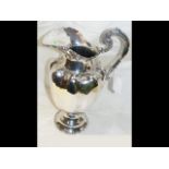 A 34cm high overall Mexican silver ewer with shaped
