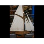 An early wooden pond yacht, the hull 10cm, on wood