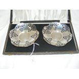 A pair of pierced silver bonbon dishes in presenta