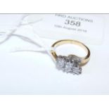 A 9ct gold three stone diamond crossover ring