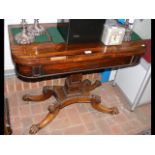 A Regency rosewood fold-over games table on shaped
