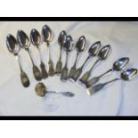 Eleven white metal pieces of flatware, including t