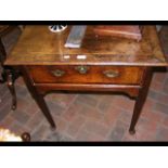 A Georgian oak lowboy with cross banded top and si