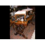 A William IV library table with shaped top and tur