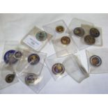 A collection of 14 small silver and enamel coins,