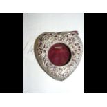 A pierced silver heart shaped pocket watch holder