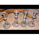 A set of four antique silver plated candlesticks -