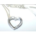 An 18ct gold diamond heart pendant on chain