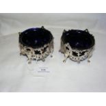 A pair of Victorian pierced silver table salts with blue glass liners - 8cm diameter - maker Yapp an