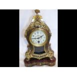 A 35cm high French red Boulle mantel clock on stan