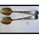 A pair of Georgian silver serving spoons - London