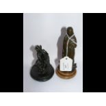 A 9cm high bronze figure of man playing bagpipes,