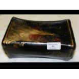 A 21cm oriental lacquered papier mache pillow with