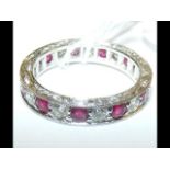 An 18ct gold ruby and diamond full eternity ring