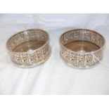 A pair of pierced silver wine coasters - 13cm diam