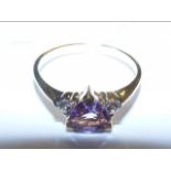 A 9ct gold amethyst ring with diamond chips to sho