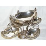 A silver table centre with four swinging baskets -