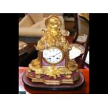 A French ormolu and porcelain mantel clock with st