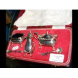 Cased set of silver condiments