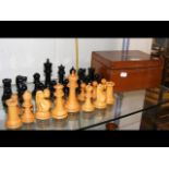 A Staunton wooden chess set - the King measuring 1