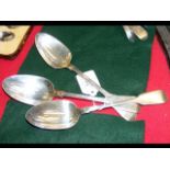 Three silver serving spoons