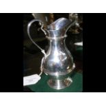 A silver footed cream jug - London hallmark - 12cm