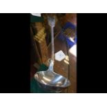 A large silver ladle with London hallmark