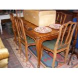 A French extending dining table with six chairs