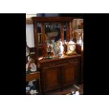 An antique mirrored back sideboard
