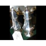 A pair of 11cm high silver salt and pepper pots