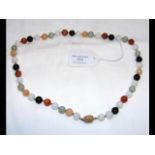 A multi-coloured jade necklace with decorative