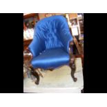 A Victorian easy chair with cabriole front support