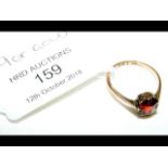 A red stone ring in 9ct gold setting