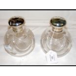 A pair of 13cm high silver top scent bottles