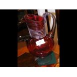 A 25cm high cranberry glass jug