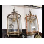 A pair of decorative glass and brass porch lamps