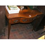 An antique mahogany bow fronted serving table with