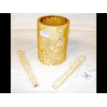 An 11.5cm high carved ivory brush pot, together wi