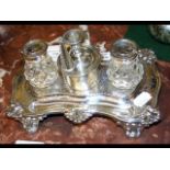 A Victorian silver desk stand with inkwells and mi