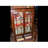 An Edwardian two door display cabinet