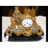 An antique French gilt mantel clock with Sevres st