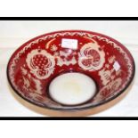 A 25cm diameter red overlay glass bowl with engrav