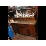 An old Arts & Crafts oak dressing table with ornat