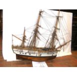 An intricate wooden model of the Endeavour with fu