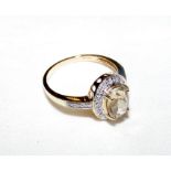 An oval gem set and diamond ring in 10k setting