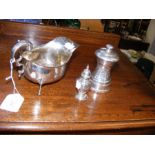 A silver sauce boat, together with a pepperette an
